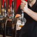 Barman pulling a pint stock image