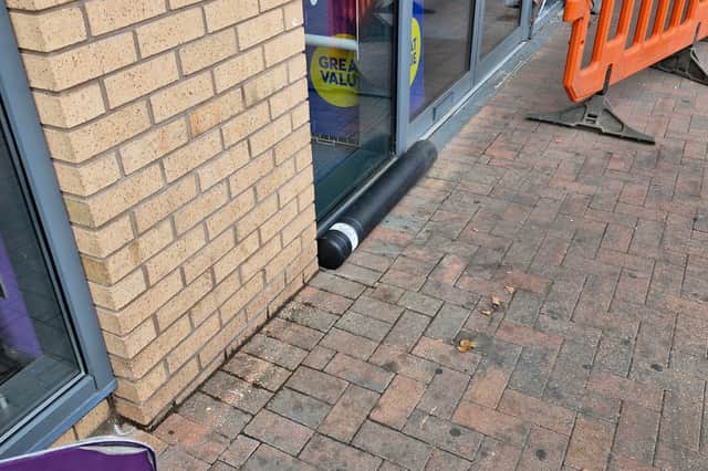The bollard hit by the car was still lying outside the shop