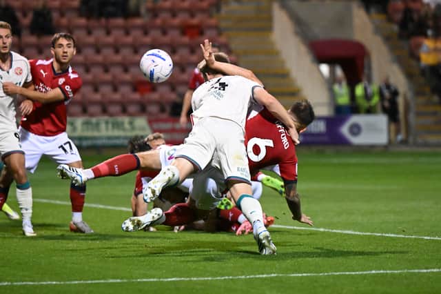 James Connolly heads at goal