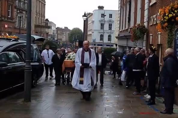 Canon Rev Jeremy Dussek walks ahead of the coffin at the funeral of ex-Wolves goalkeeper Phil Parkes