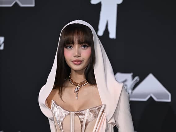 Lisa wearing a white gown with hood at the MTV Video Music Awards.