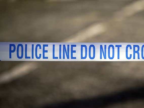Police tape near the scene of a suspected crime