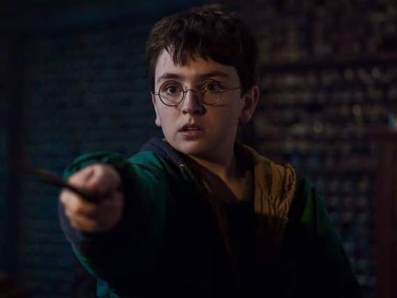 A scene from the new Harry Potter film showing the young wizard waving his wand