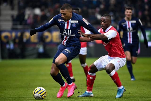 Ghislain Konan (right) contests Kylian Mbappe during a game between Stade de Reims and Paris Saint-Germain in 2020.
