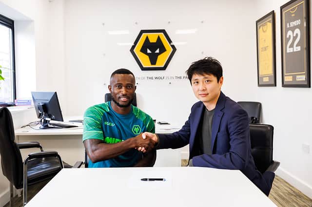 New arrival Ghislain Konan (left) with Wolves chairman Nathan Shi (Photo by Brett Patzke - WWFC/Wolves via Getty Images)