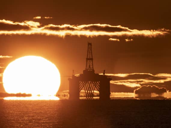 A sunset behind an oil rig