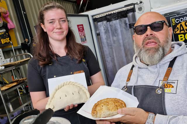 Kyla Bickley shows off the 1kg pasty alongside the original being held by Darren Bassett