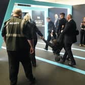 A protester is removed during Nigel Farage's speech at the Reform UK conference
