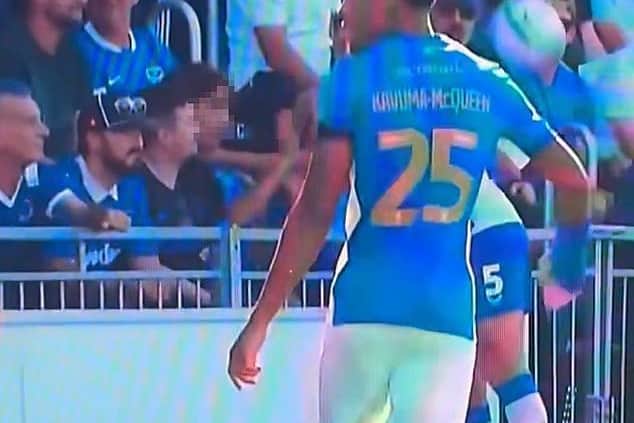 Former Albion defender Krystian Bielik's outstretched arm can be seen seemingly reacting to a young Portsmouth supporter.