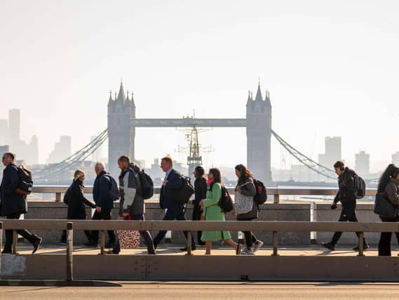 Commuters walking across London Bridge