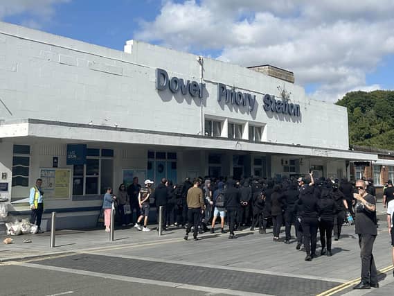 Men dressed in black outside Dover Priory Station