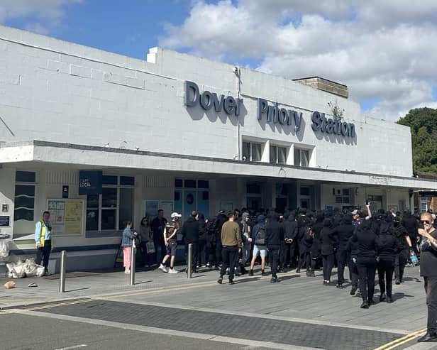 Men dressed in black outside Dover Priory Station