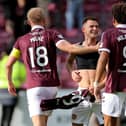 Saba Kerjota (centre) celebrates