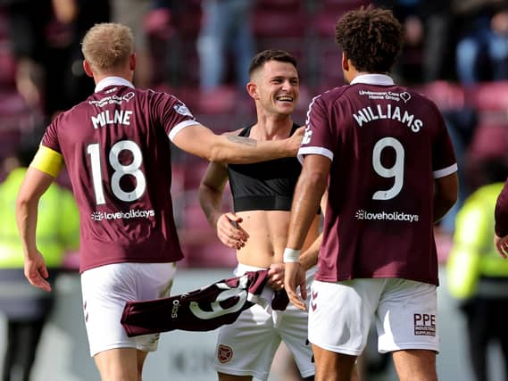 Saba Kerjota (centre) celebrates