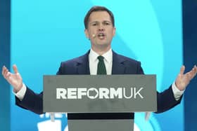 Robert Jenrick speaking from behind a Reform UK lectern