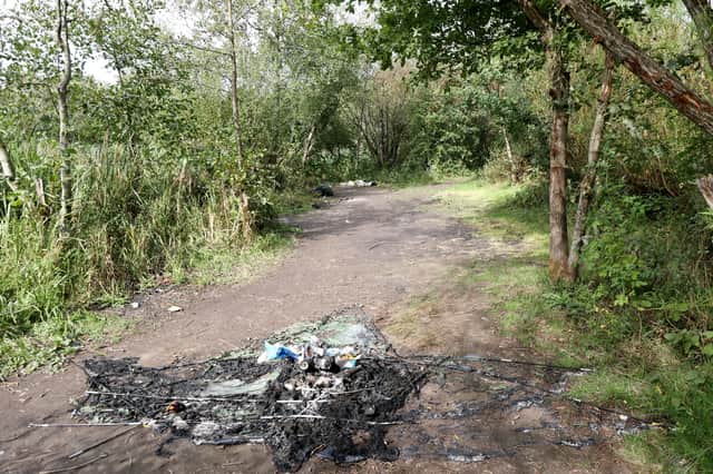Burnt rubbish on a footpath in the nature reserve