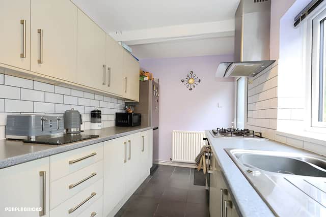 The fitted kitchen sits at the rear, with views stretching across the expansive private garden