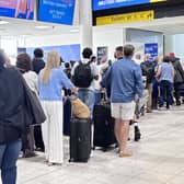 Passengers queue at Gatwick Airport
