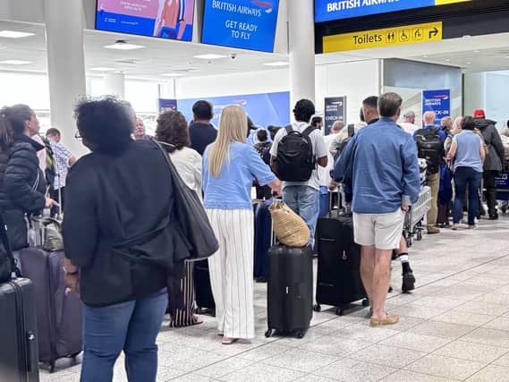 Passengers queue at Gatwick Airport
