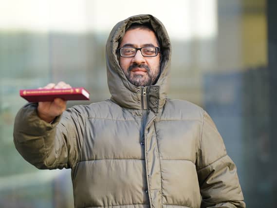 Urslaan Khan holding a book