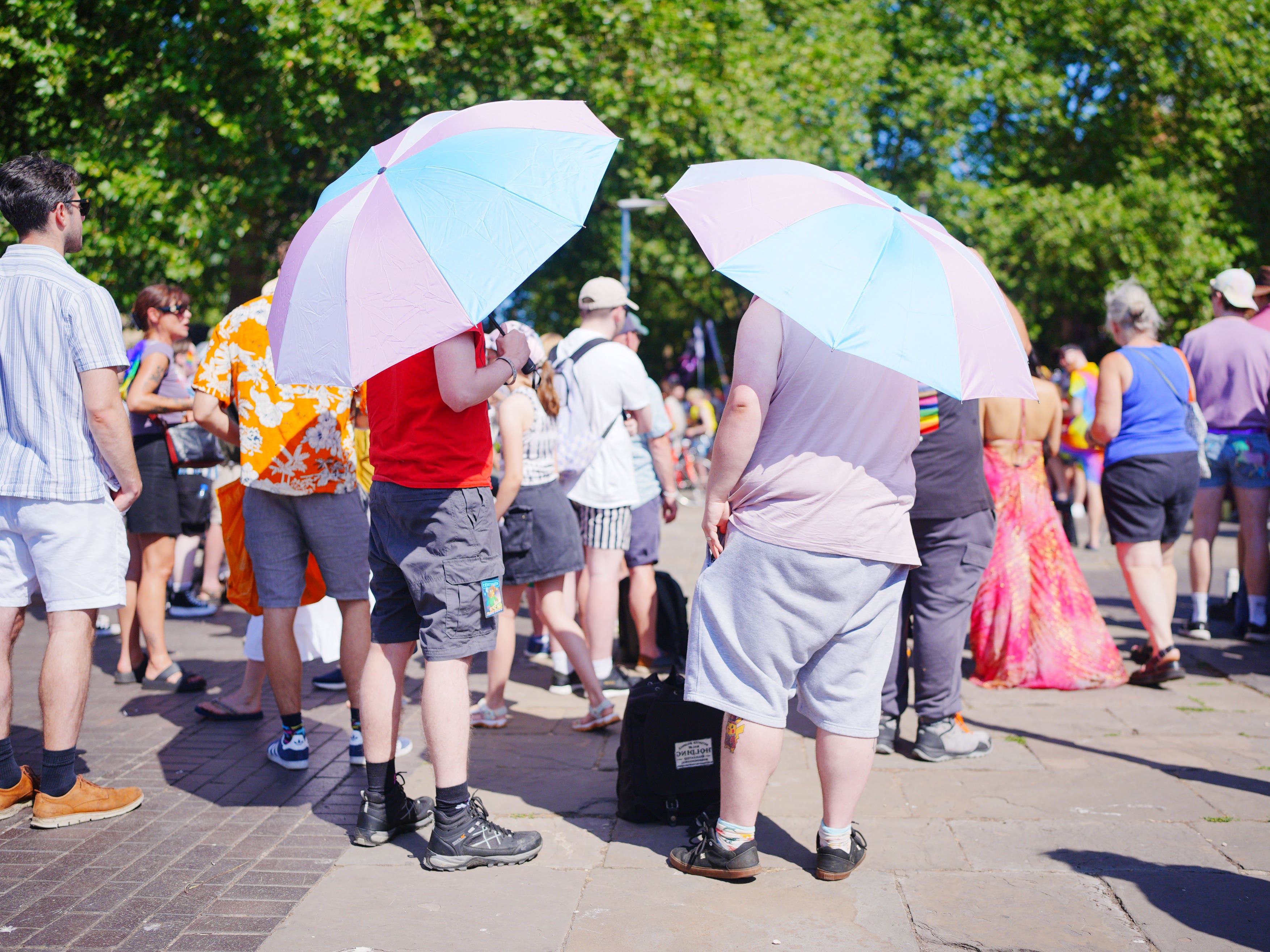 People use umbrellas for shade