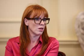 Angela Rayner seated, wearing glasses and a pink shirt