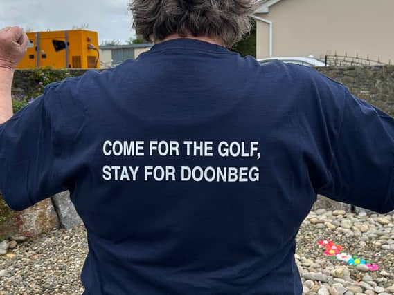 A man wears a t-shirt promoting Doonbeg