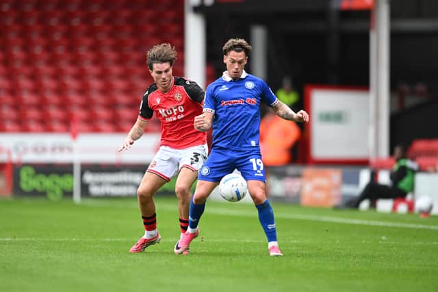 Walsall left-back Mason Hancock challenges for the ball.
