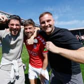 Alex Newby, centre, celebrates