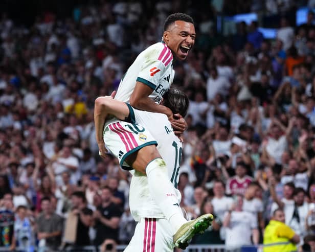 Kylian Mbappe jumps on Alvaro Carreras