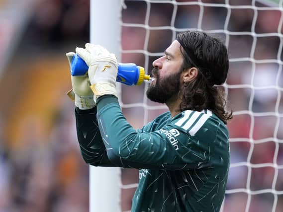 Liverpool goalkeeper Alisson Becker takes a drink during a match