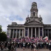 View of a group of protesters, with many waving UK and English flags