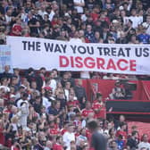 Manchester United fans display a banner in protest in the stands