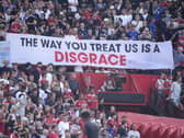 Manchester United fans display a banner in protest in the stands