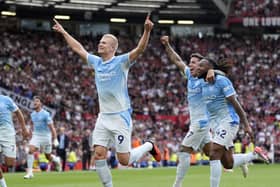 Manchester City striker Erling Haaland celebrates scoring against Manchester United at Old Trafford