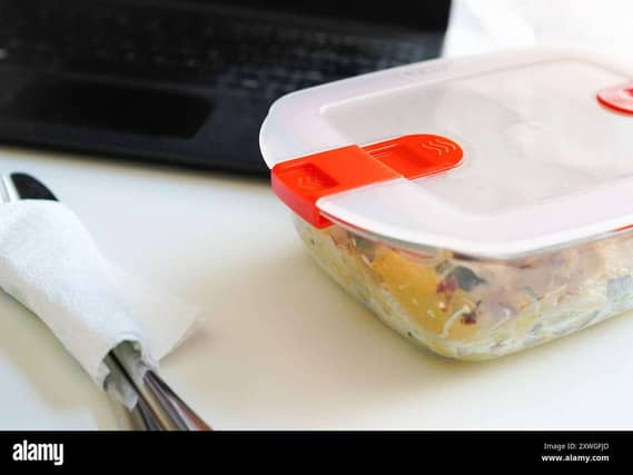 Lunch with pasta in Tupperware at the office desk