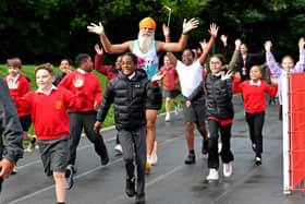 Fundraiser Manny Singh Kang joins pupils at Hill Avenue Academy, Wolverhampton to run a mile around the playground. Manny is visiting 50 schools in two days.
Tim Thursfield/Iconic Media Group