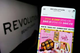 The Revolution Beauty website displays on a laptop and a mobile phone
