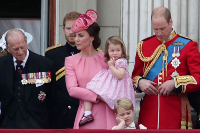 The Duke of Edinburgh, the Duchess of Cambridge holding Princess Charlotte, Prince George and the Duke of Cambridge on the balcony of Buckingham Palace (Yui Mok/PA)