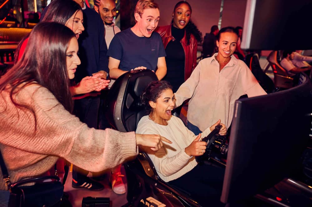 People enjoying a watch party at F1 Arcade