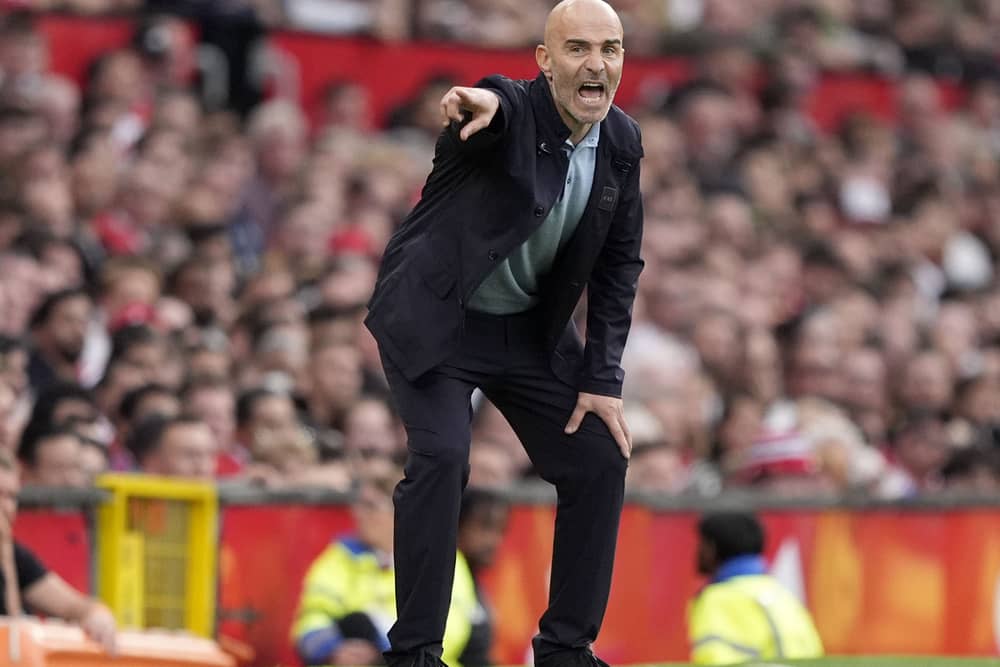 Manchester City manager Enzo Maresca crouches on the touchline