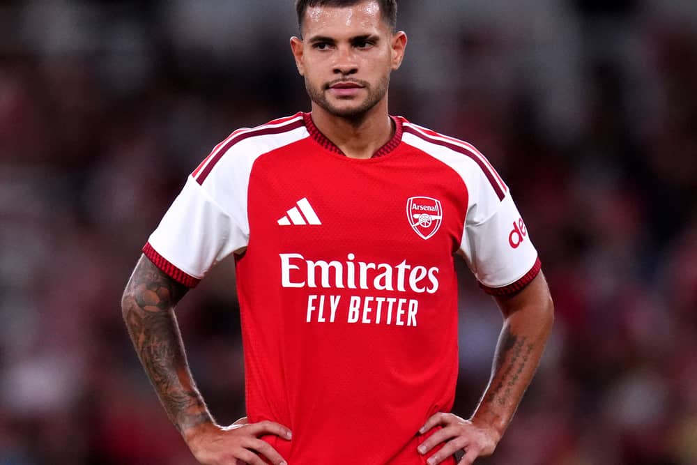 Arsenal midfielder Bruno Guimaraes stands with his hands on his hips