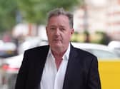 Head and shoulders photo of Piers Morgan walking outside
