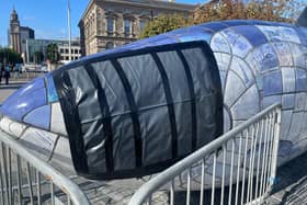 The Big Fish sculpture, with damage taped off