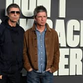 Liam and Noel Gallagher posing for photos
