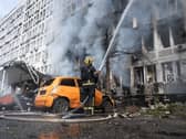 Firefighters tackle a blaze at a building following a Russian drone strike in Kyiv
