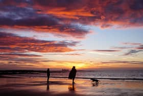 People walking on Tynemouth beach
