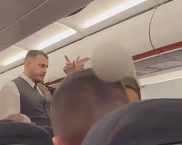 Still from footage shows the moment a group of four are escorted off a plane shortly after landing in Birmigham for allegedly vaping throughout the five-hour flight