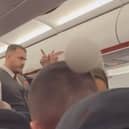 Still from footage shows the moment a group of four are escorted off a plane shortly after landing in Birmigham for allegedly vaping throughout the five-hour flight