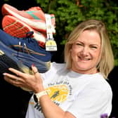 Compton Care community and events manager Emily Thompson gets her running shoes ready for the Half Marathon on Sunday.

